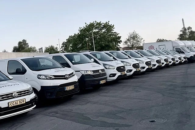 Række af hvide varevogne fra Nemovo parkeret på en parkeringsplads
